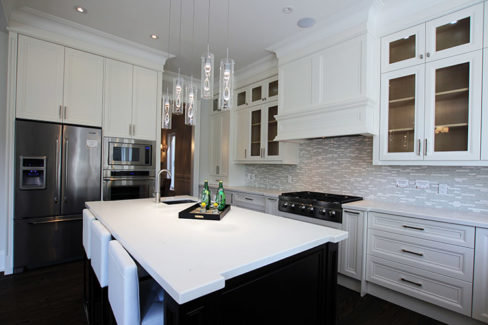 Custom made, high- end kitchen designed and built in a new house. Nine feet ceiling. Cabinets reached to the ceiling with double stack glass Kitchen cabinets, riser and crown molding. Painted MDF kitchen. Built in appliances. Quartz counter top and sink on the island. Kitchen design and built by JK. Richmond hill 2015
