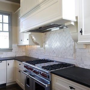  Transitional White Kitchen With Mantel Hood And Black Countertop