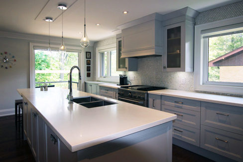 Kitchen renovation in GTA. Custom Made transitional painted Kitchen. Mantel hood above cooking area and glass doors. With riser and crown molding upper cabinets reaches to the ceiling. Designed and built by JK. Thornhill 2016