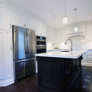 Kitchen renovation.Custom made solid wood framed kitchen. Mantel hood above the cooking area. Off white painted kitchen and dark stained island. Designed and built by JK- North York, 2017