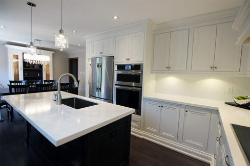 Custom made solid wood kitchen. Painted off white kitchen cabinets and stained island. Custom made wall unit in breakfast area. Designed and built by JK, North York 2017