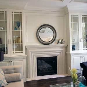 Glass doors wall unit. Painted white wall unit to the sides of fire place. Designed a built by JK. Thornhill