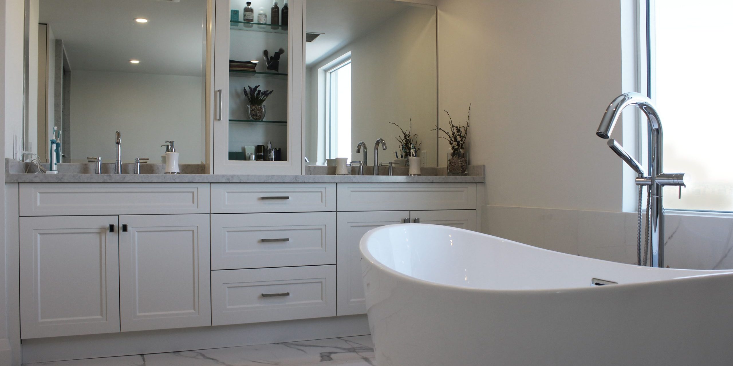 Bathroom remodeling Toronto. Custom made off white painted MDF, double sink vanity. Medicene box. Quartz countertop. Porcelaine floor. Design and whole renovation by JK.