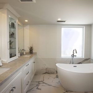 Master bedroom bathroom renovation , double sink vanity with shallow tower in the center- free stand bathtub. Marble, white and gray floor porcelain tiles. Design and built by Joseph Kitchen North York 2019.Toronto