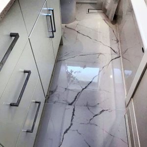 Bathroom renovation in Markham by Joseph kitchen and Bath. Modern white custom made vanity. Quartz countertop . Large Calacatta floor porcelain tiles.