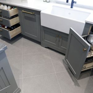 Corner pull out to let access dead corners in base cabinets. Can holds heavy objects and pots. By JK Markham