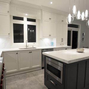 Two tone kitchen. White cabinets and gray island. Water fall island with white and gray Calacatta pattern. for a luxury look. Designed and built by Joseph kitchen. Markham 2019