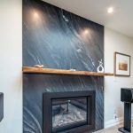 Fire place renovation, quartz wall stone and walnut wood floating shelf. Design & build by JK Markham .
