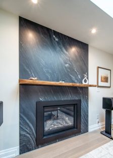 Fire place renovation, quartz wall stone and walnut wood floating shelf. Design & build by JK Markham .