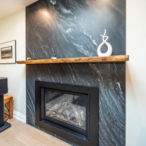 Fire place renovation, quartz wall stone and walnut wood floating shelf. Design & build by JK Markham . ()