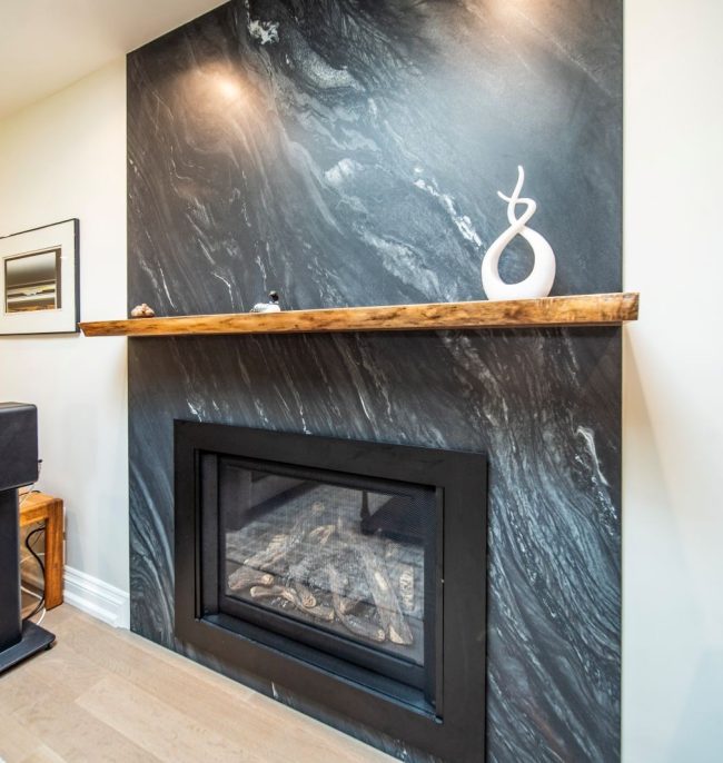 Fire place renovation, quartz wall stone and walnut wood floating shelf. Design & build by JK Markham . () Fire place renovation, quartz wall stone and walnut wood floating shelf. Design & build by JK Markham . ()