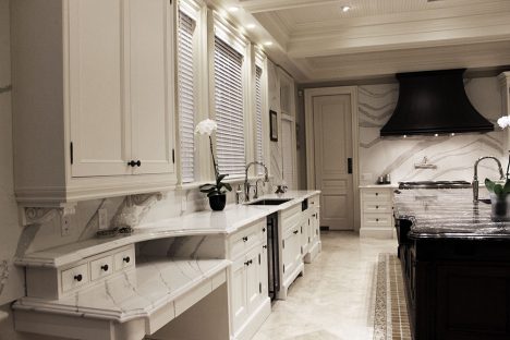 Framed solid wood kitchen cabinets. Copper hood and stained island in dark brown. Counter by Cambria by JK North York 2018