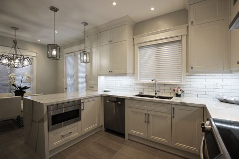 Kitchen renovation. Custom made kitchen . Designed by JK Richmond Hill 2019. Painted off white kitchen. Built in appliances. White and gray quartz counter top. Water fall counter top. Under cabinet light.