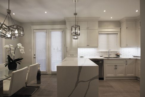 Kitchen renovation by Joseph kitchen in Richmond Hill. Painted off white kitchen cabinets. Double stack upper cabinets. White and gray Quartz counter top. Water fall peninsula. Under cabinet light. 2019