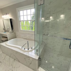 High end bathroom remodeling. Built in tub. white and gray bathroom color palet. Toronto