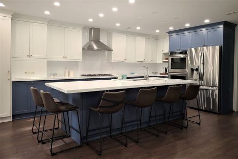 High end kitchen remodeling in Toronto Two tone modern kitchen cabinets. White and blue painted MDF cabinets White quartz countertop and back splash Conestructed in