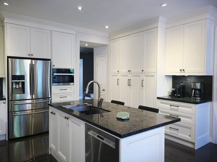 High end kitchen remodeling. Tall kitchen ceiling double stacked upper cabinets. Painted MDF white cabinets and dark quartz countertop. Off gold handles and knobs. Design and built by Joseph Kitchen and Bath 2021