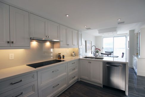 Kitchen make overcustom made transitional painted off white solid maple wood kitchen cabients. Gelux counter top. Built and design by Joseph kitchen Toronto