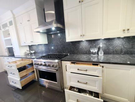 Kitchen remodeling in GTA. Kitchen organizers and kitchen pull outs. Richmond Hill. Kitchen design and construction by Joseph Kitchen and Bath. Painted off white kitchen cabinets and dark quartz counter top and backsplash. Project contractor JK 2021