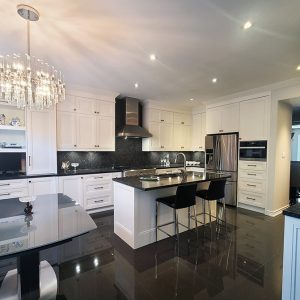 Kitchen renovation in Richmond Hill. A U shaped kitchen with island. Wall unit and pantery. Double stacked cabinets. Painted MDF. Quartz top.