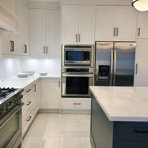 Kitchen renovation in Richmond Hill. Custom kitchen cabinets. Two tone white and gray kitchen design. Canadian quartz countertop and backsplash.