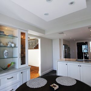 Luxury highend kitchen renovation in a penthouse. Off white kitchen cabintets and wall unit in breakfast area. Design and built by Joseph Kitchen Toronto
