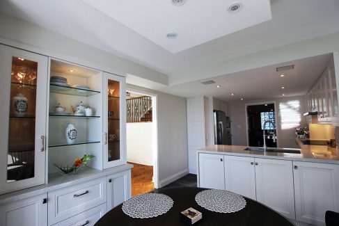 Luxury highend kitchen renovation in a penthouse. Off white kitchen cabintets and wall unit in breakfast area. Design and built by Joseph Kitchen Toronto