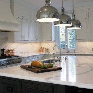 Kitchen renovation. Two tone kitchen cabinets. White and gray quartz counter top from Cambria- Brittanicca. Luxury counter top edge. Dark solid wood stained island and painted white kitchen cabinets. Designed and built by Joseph kitchen Markham 2019