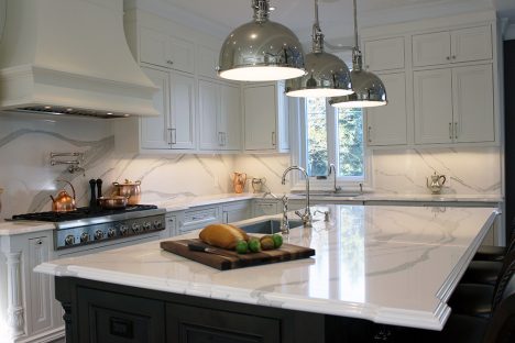 Kitchen renovation. Two tone kitchen cabinets. White and gray quartz counter top from Cambria- Brittanicca. Luxury counter top edge. Dark solid wood stained island and painted white kitchen cabinets. Designed and built by Joseph kitchen Markham 2019
