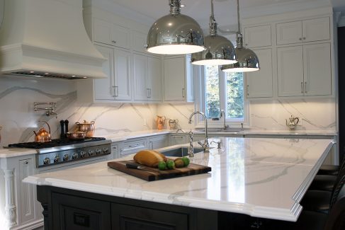 Kitchen renovation. Two tone kitchen cabinets. White and gray quartz counter top from Cambria- Brittanicca. Luxury counter top edge. Dark solid wood stained island and painted white kitchen cabinets. Designed and built by Joseph kitchen Markham 2019
