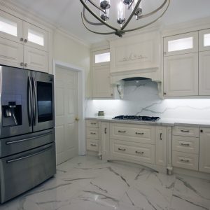Kitchen renovation. Transitional white kitchen.. Custom designed mantel hood. Double stack cabinets reaches to the ceiling. Toronto 2019