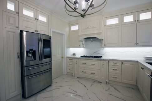 Kitchen renovation. Transitional white kitchen.. Custom designed mantel hood. Double stack cabinets reaches to the ceiling. Toronto 2019