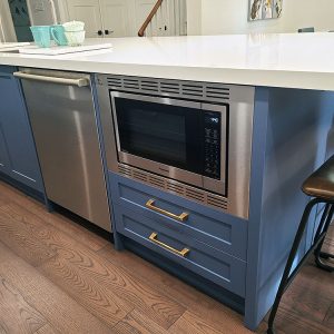 White and blue modern island Painted MDF Built in microwave sink on the islad construction and renovation by Joseph kitchen and bath