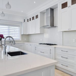 Contemporary off withe kitchen. Double stack kitchen reached to the ceiling with riser and crown molding. Pure white quartz counter top. Large pot drawers and spice pull outs. Sink on the island. North York 2017
