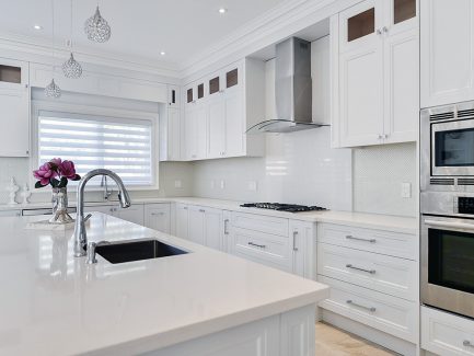 Contemporary off withe kitchen. Double stack kitchen reached to the ceiling with riser and crown molding. Pure white quartz counter top. Large pot drawers and spice pull outs. Sink on the island. North York 2017