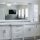 A modern white bathroom vanity with double sinks and a large mirror.