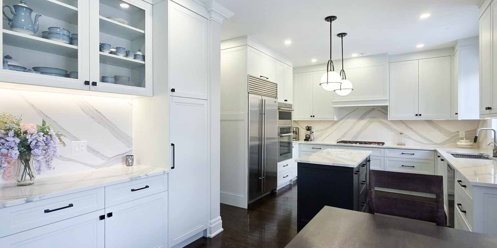 usersFfed afe da afffacdFlibraryFa c efc aceF Copy Modern white kitchen with a large stainless steel refrigerator and island.