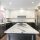 Modern kitchen with black and white cabinets and granite island.