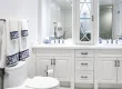 White bathroom with blue and white towels and decor.