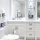 White bathroom with blue and white towels and decor.