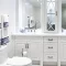White bathroom with blue and white towels and decor.